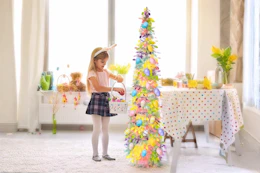 Lifestyle image of 5-foot Easter tree being decorated by a child