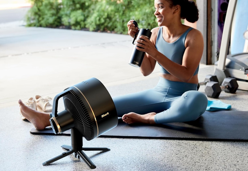 Someone sitting in front of Shark cordless fan during a workout. 
