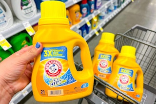 hand holding a bottle of arm & hammer laundry detergent