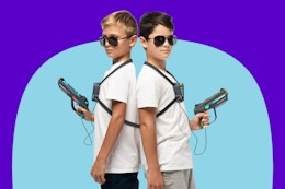 Two kids holding laser tag guns from Hero Squads playset