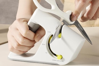 a woman using a knife sharpener