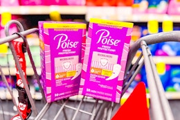 2 boxes of poise pantyliners in a cart