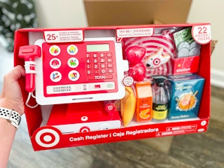 Hand holding the target cash register toy