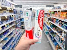 hand holding colgate oral care products in walgreens