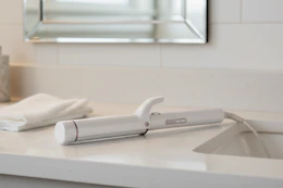 curling iron on a bathroom counter 