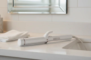 curling iron on a bathroom counter