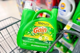 large jug of gain detergent in a cart