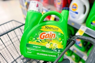 large jug of gain detergent in a cart