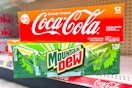 coca-cola and mountain dew 12-packs stacked on store shelf