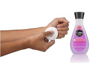 A person using a cotton pad to remove nail polish.