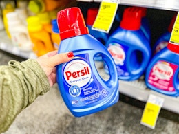 person holding a bottle of persil detergent