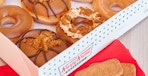 krispy kreme biscoff doughnuts in box near lotus cookies