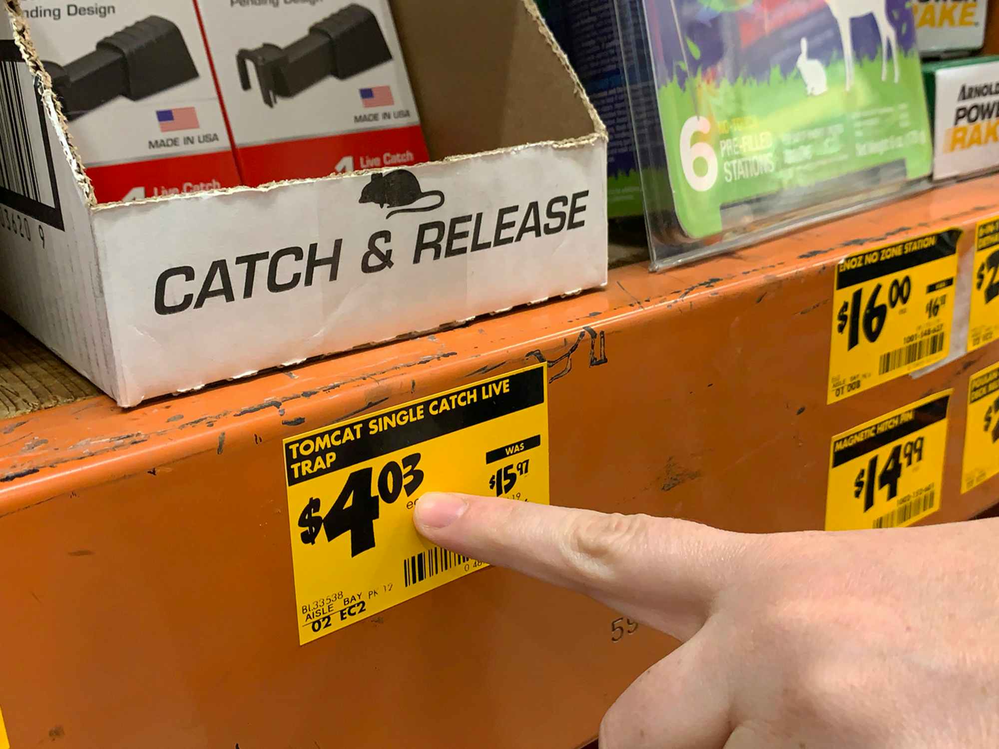 A hand pointing at a price tag ending in three