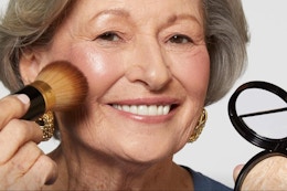 a woman wearing a makeup brush