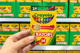 hand holding a box of crayola crayons