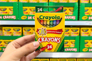 hand holding a box of crayola crayons