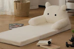 kids' sofa bed on floor next to books
