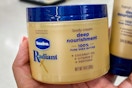 hand holding vaseline radiant x body cream