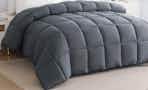 Lifestyle image of grey quilted Down Alternative Comforter on bed in bedroom