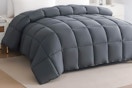 Lifestyle image of grey quilted Down Alternative Comforter on bed in bedroom
