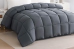 Lifestyle image of grey quilted Down Alternative Comforter on bed in bedroom