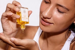 woman applying oil to hands