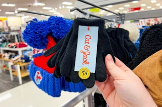 hand grabbing a set of kids' winter gloves off a target shelf