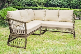 Lifestyle image of the Style Selections Wicker Outdoor Sectional with Cream Cushions outside