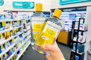 hand holding two bottles of dickinson's witch hazel toner