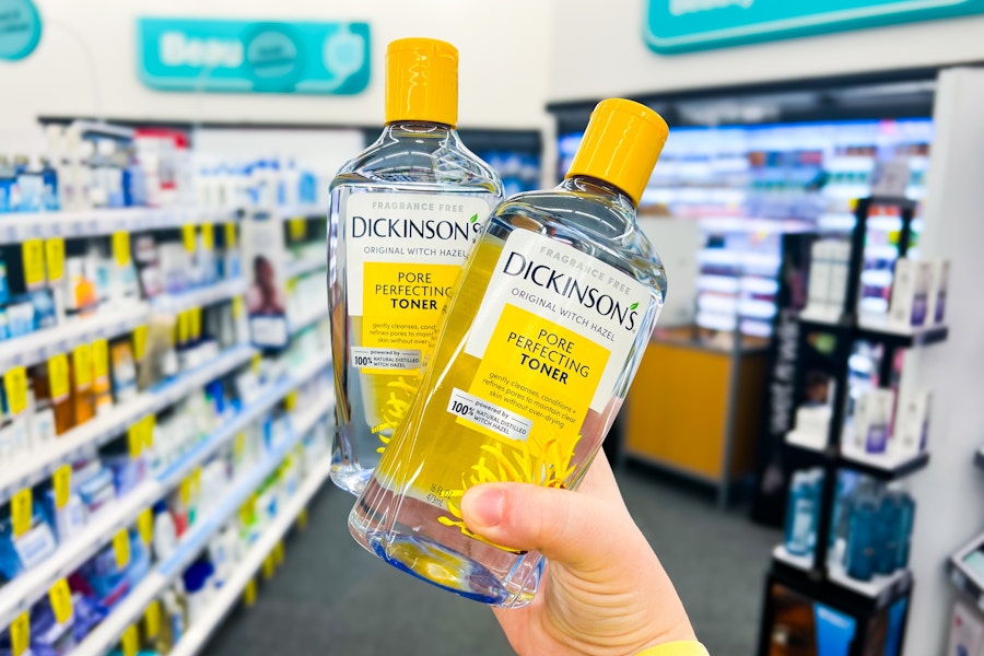hand holding two bottles of dickinson's witch hazel toner