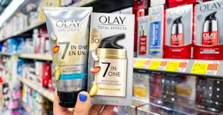hand holding olay total effects 7-in-one moisturizer with sunscreen spf 30 and revitalizing foaming cleanser in walmart aisle