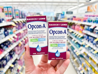 hand holding opcon eyedrops