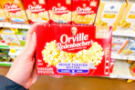 hand holding a box of orville redenbachers popcorn