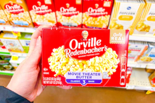 hand holding a box of orville redenbachers popcorn