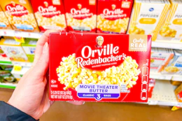 hand holding a box of orville redenbachers popcorn