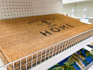 threshold outdoor floral doormat sitting in a target cart