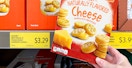 person's hand holding box of savoritz mini naturally flavored cheese sandwich crackers from aldi