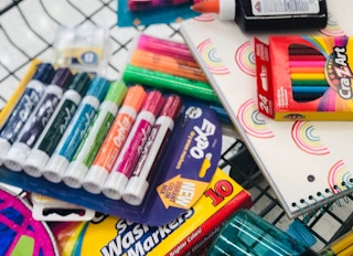 Back to school supplies in a shopping cart.