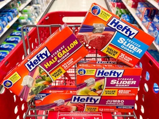 A variety of hefty bag boxes sitting in a store cart