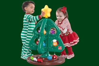 two little kids by a step2 christmas tree