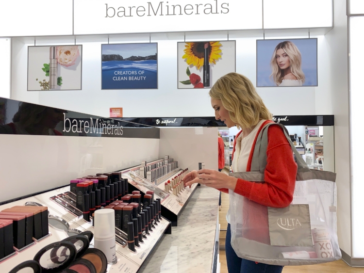 A person looking at bareMinerals lipstick in Ulta.