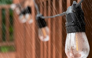 A set of string lights in the rain.