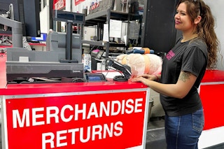 a person standing in front of return counter in costco