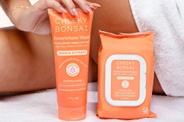 Lifestyle image of Cheeky Bonsai products held up next to person's leg (close up shot)