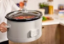 hand holding a large bella programable slow cooker