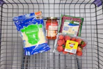 shredded cheese, pizza sauce, strawberries, and ground beef in a cart