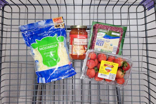 shredded cheese, pizza sauce, strawberries, and ground beef in a cart