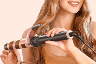 a woman curling her hair