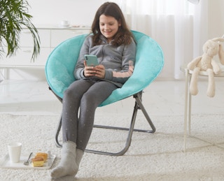 stock photo of girl sitting in mainstays saucer chair