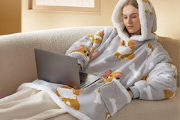 a woman using a bedsure corgi heated wearable blanket